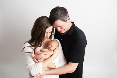 mom, dad and newborn baby in arms, baby girl newborn