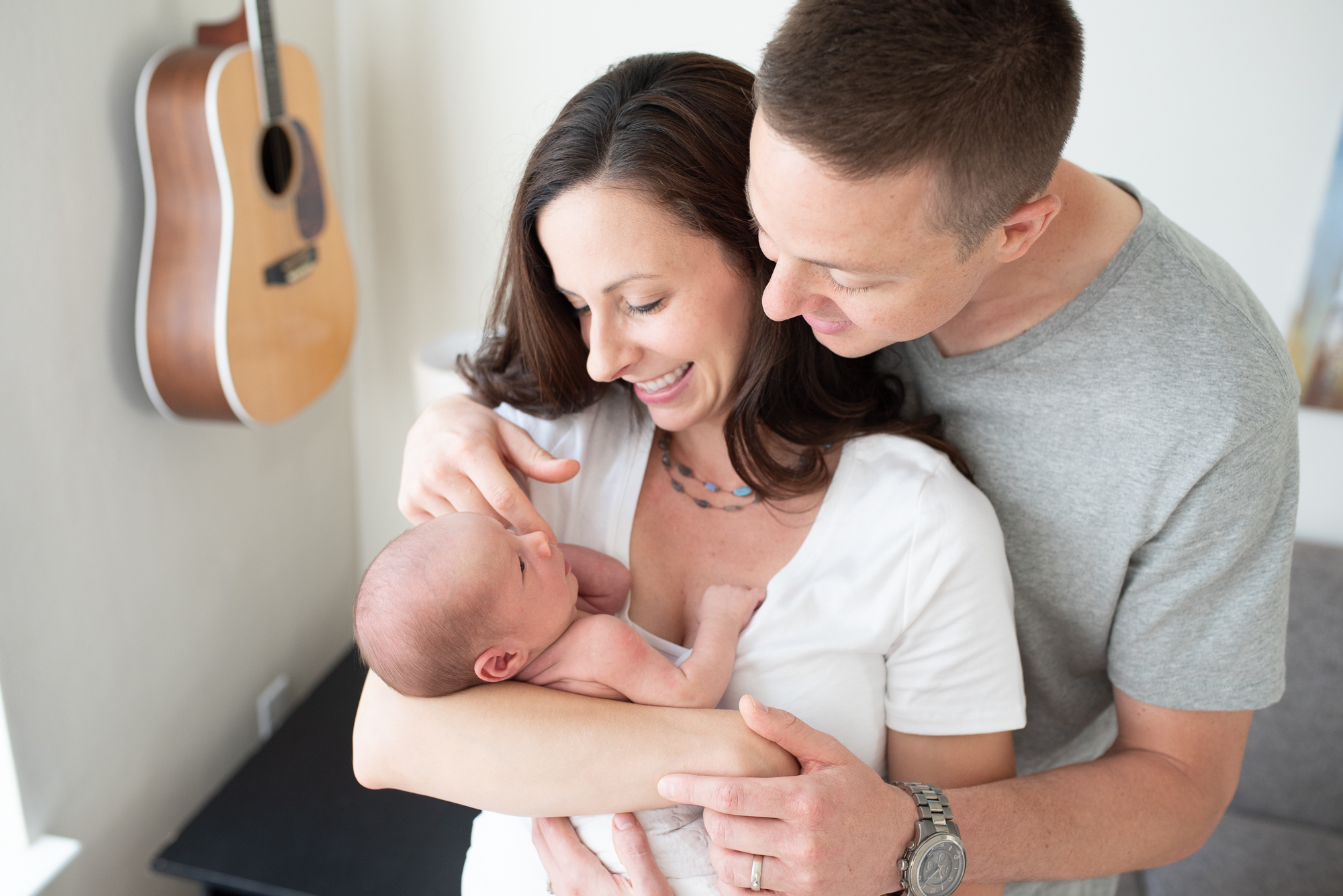 mom and dad holding newborn